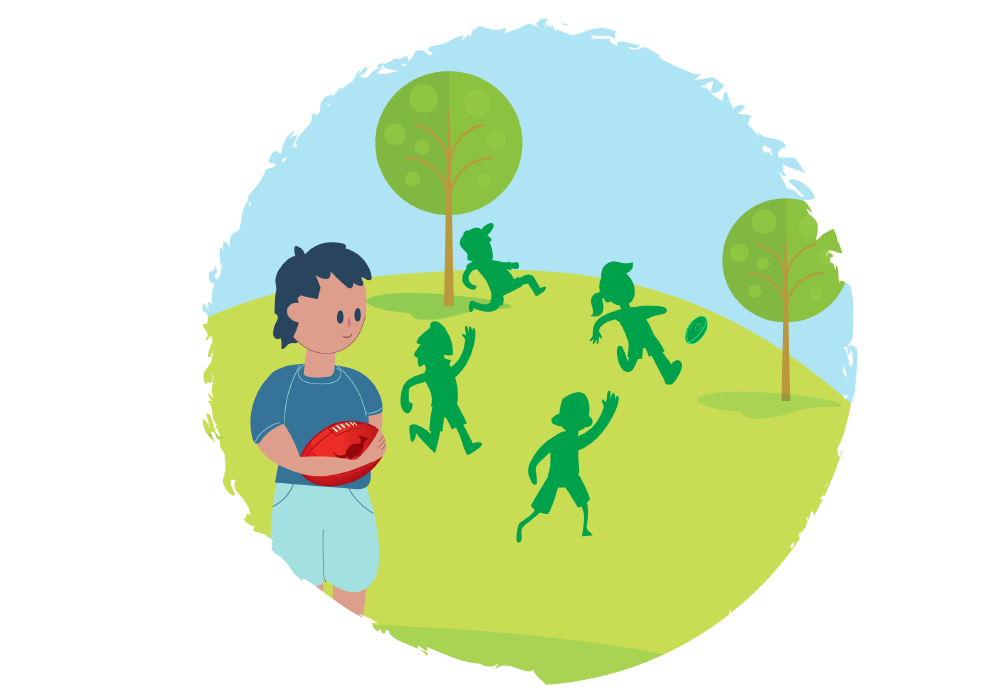 Boy with an AFL ball looking at other kids playing